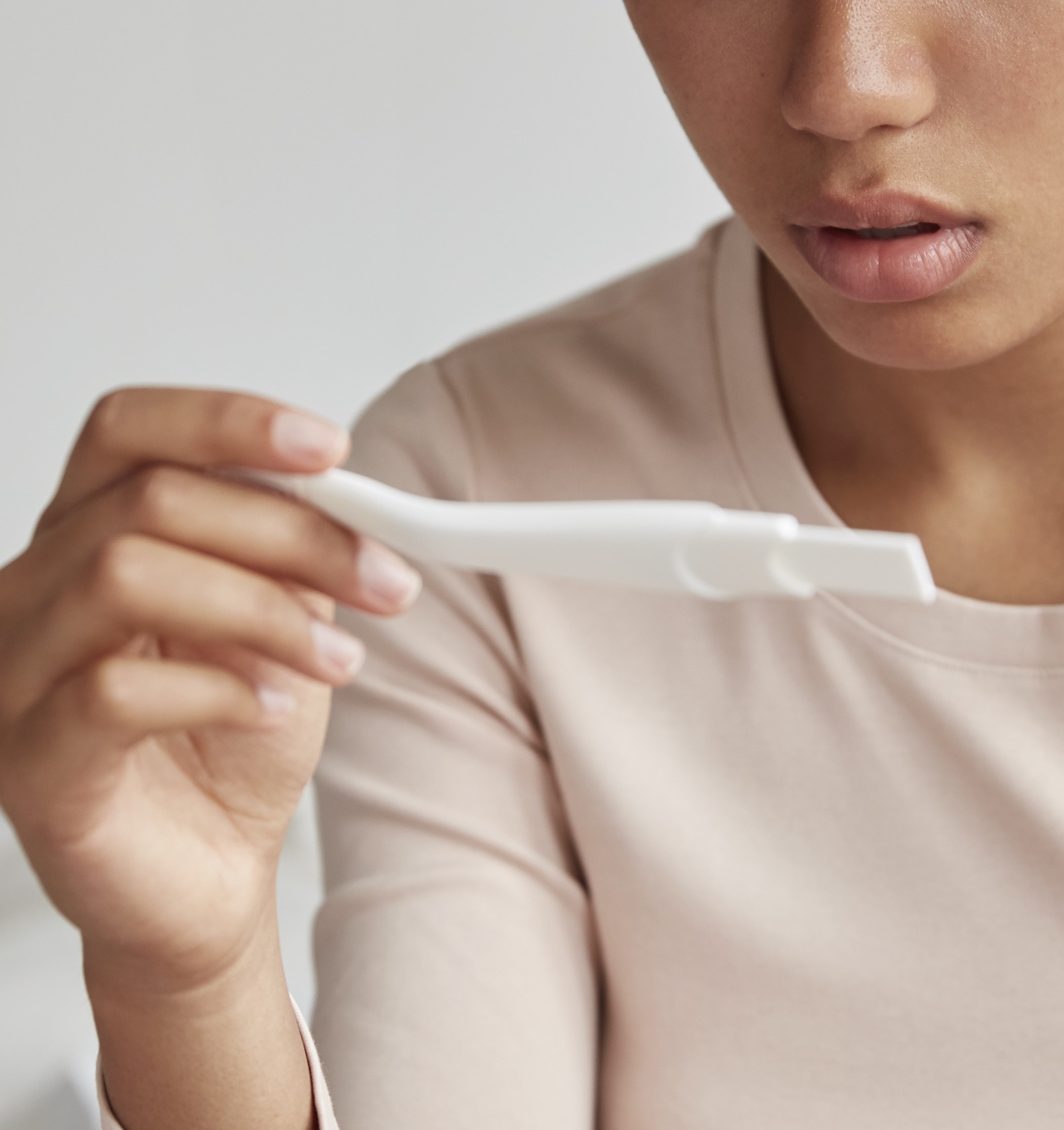 Pregnancy Tests A woman holding a free pregnancy test at Clarity Clinic