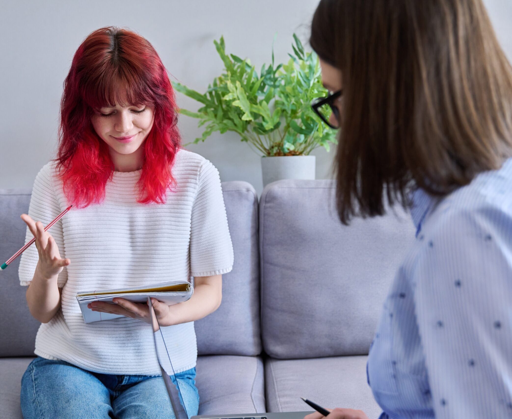 Teenage girl with notebook in consultation